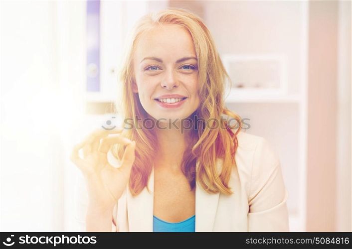 business, gesture, success, startup and people concept - happy businesswoman showing ok sign at office. happy businesswoman showing ok sign at office. happy businesswoman showing ok sign at office