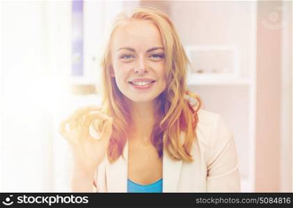 business, gesture, success, startup and people concept - happy businesswoman showing ok sign at office. happy businesswoman showing ok sign at office. happy businesswoman showing ok sign at office