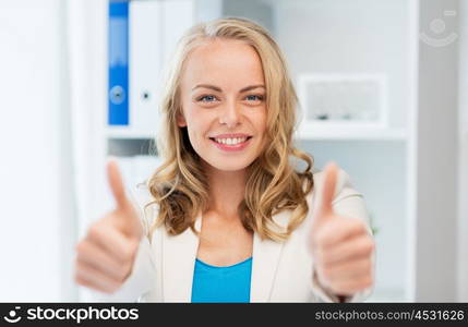 business, gesture, success, startup and people concept - happy businesswoman showing thumbs up at office