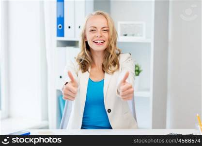 business, gesture, success, startup and people concept - happy businesswoman showing thumbs up at office