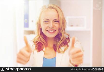 business, gesture, success, startup and people concept - happy businesswoman showing thumbs up at office. happy businesswoman showing thumbs up at office