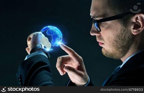 business, globalization and technology concept - close up of businessman with smart watch and earth hologram over black. businessman with smart watch and earth hologram. businessman with smart watch and earth hologram