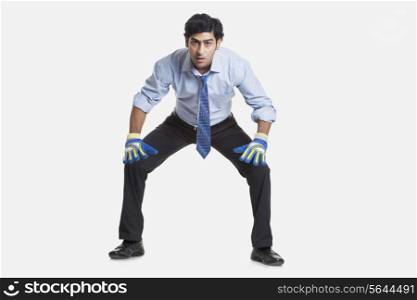 Business goalkeeper ready to save the goal over white background