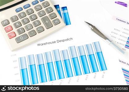 Business graph with pen and calculator on it