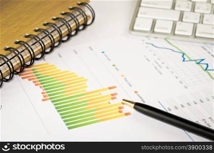 Business graphs and pen analysis report. Accounting