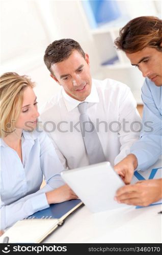 Business group around table with electronic tablet