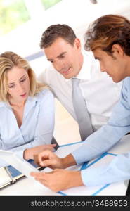 Business group around table with electronic tablet