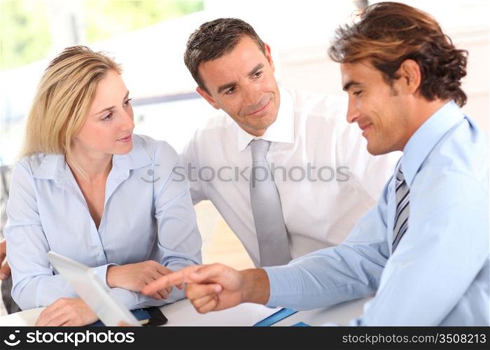 Business group around table with electronic tablet
