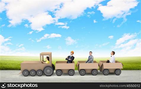 Business group. Young business people riding carton train. Teamwork concept