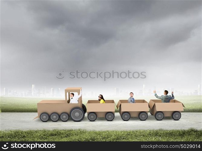 Business group. Young business people riding carton train. Teamwork concept