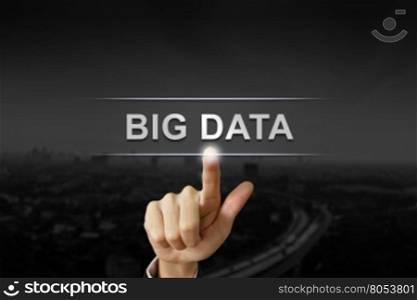 business hand clicking big data button on black blurred background