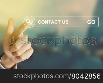 business hand clicking contact us button on search toolbar with vintage style effect