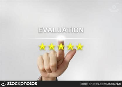 business hand clicking evaluation with five stars on screen