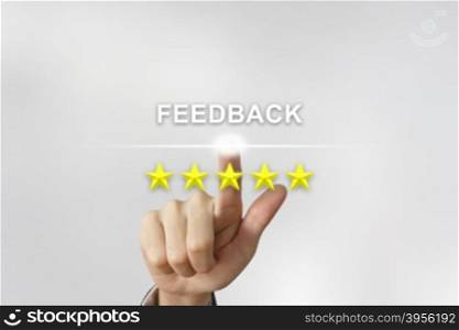 business hand clicking feedback with five stars on screen