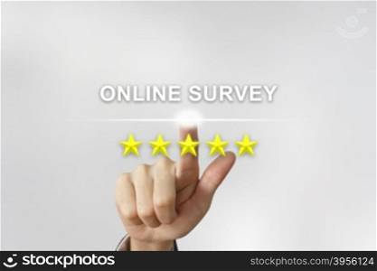 business hand clicking online survey with five stars on screen