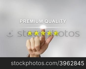 business hand clicking premium quality with five stars on screen