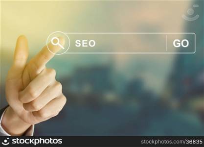 business hand clicking SEO or Search engine optimization button on search toolbar with vintage style effect