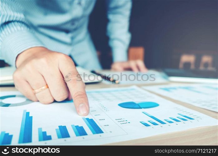 Business hand pointing on the business paper. Report chart