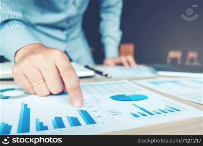 Business hand pointing on the business paper. Report chart