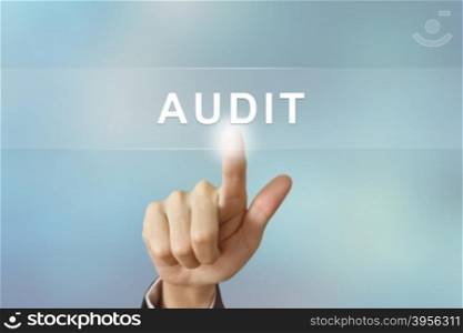 business hand pushing audit button on blurred background