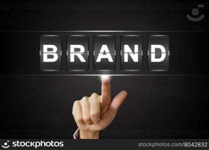 business hand pushing brand on Flipboard Display
