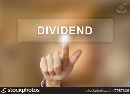 business hand pushing dividend button on blurred background