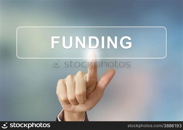 business hand pushing funding button on blurred background