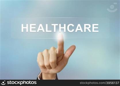 business hand pushing healthcare button on blurred background
