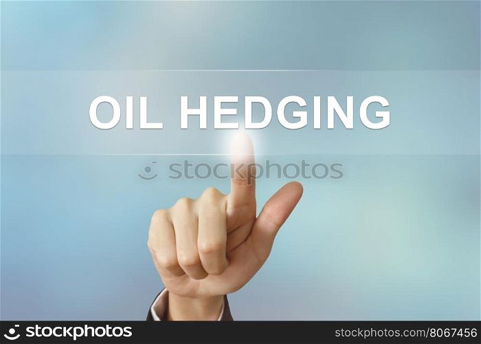 business hand pushing oil hedging button on blurred background