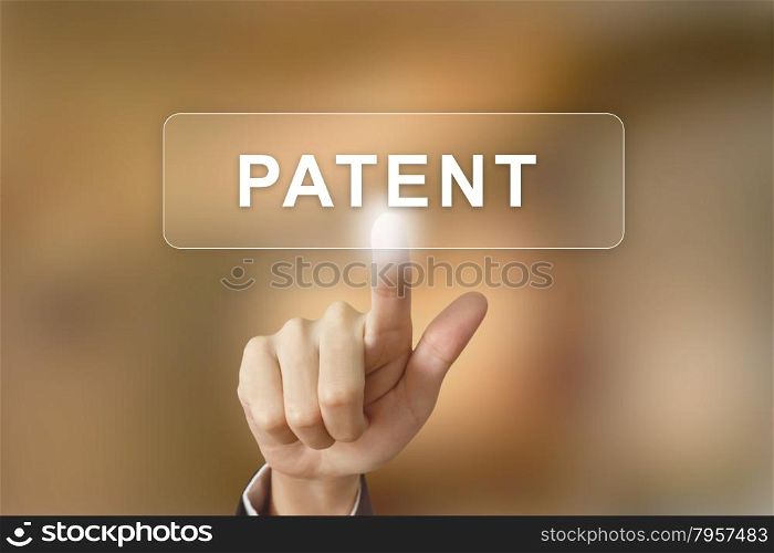 business hand pushing patent button on blurred background