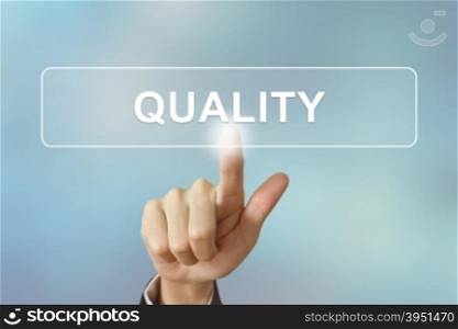 business hand pushing quality button on blurred background