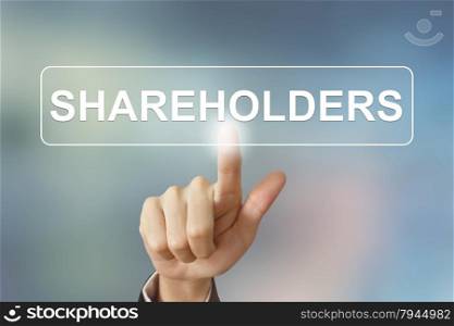 business hand pushing shareholders button on blurred background