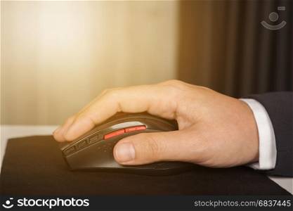 business hand working with mouse of computer with sunlight
