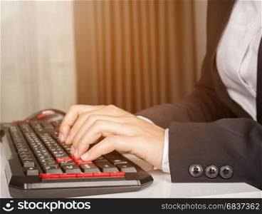 business hands working on computer keyboard with sunlight
