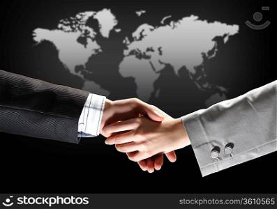 business handshake against black background with map image