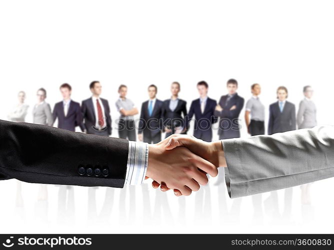 business handshake against white background and standing businesspeople