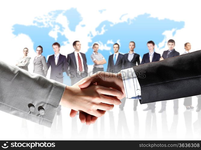 business handshake against white background and standing businesspeople