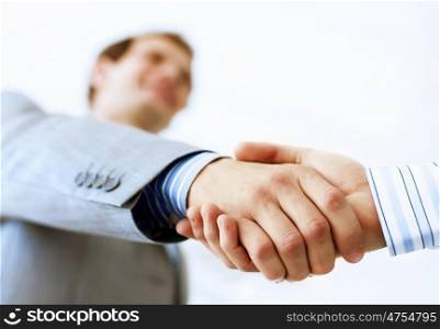 Business handshake. Close up image of business handshake at meeting. Partnership concept