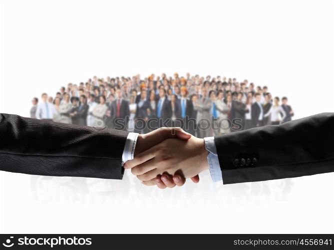 Business handshake. Handshake of business people with people at background