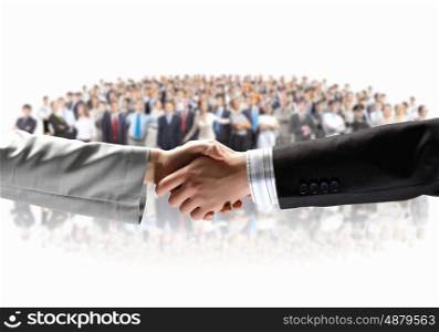 Business handshake. Handshake of business people with people at background