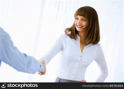 Business handshake. Image of businesswoman greeting colleague. Partnership concept