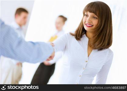 Business handshake. Image of businesswoman greeting colleague. Partnership concept