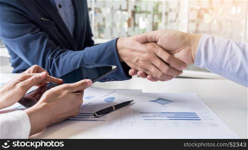 Business handshake of two men demonstrating their agreement to sign agreement or contract between their firms, companies, enterprises