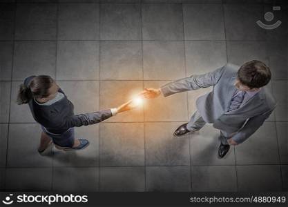 Business handshake. Top view of a businessman and woman shaking hands in office lobby