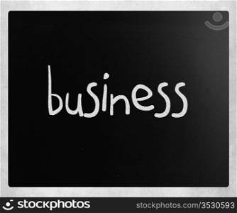 ""Business" handwritten with white chalk on a blackboard."
