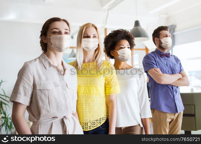 business, health and people concept - office workers wearing face protective medical masks for protection from virus disease. business team in masks in office