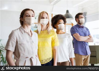 business, health and people concept - office workers wearing face protective medical masks for protection from virus disease. business team in masks in office