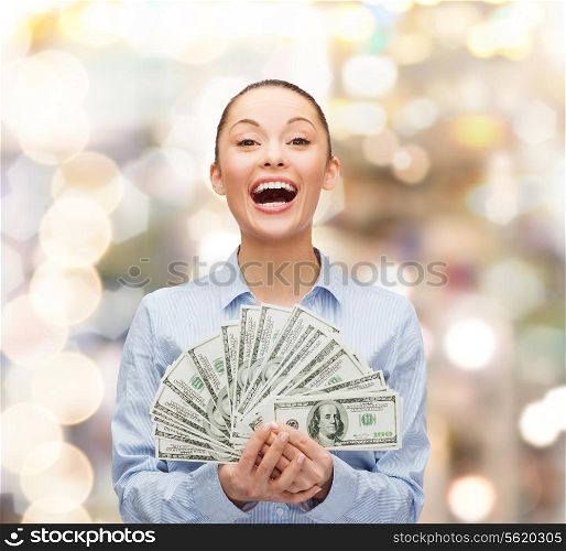 business, holidays and people concept - laughing businesswoman with dollar cash money