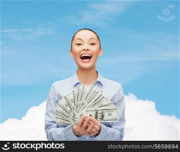 business, holidays and people concept - laughing businesswoman with dollar cash money over blue sky with white cloud background