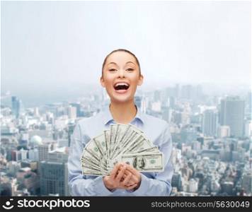 business, holidays and people concept - laughing businesswoman with dollar cash money over cityscape background